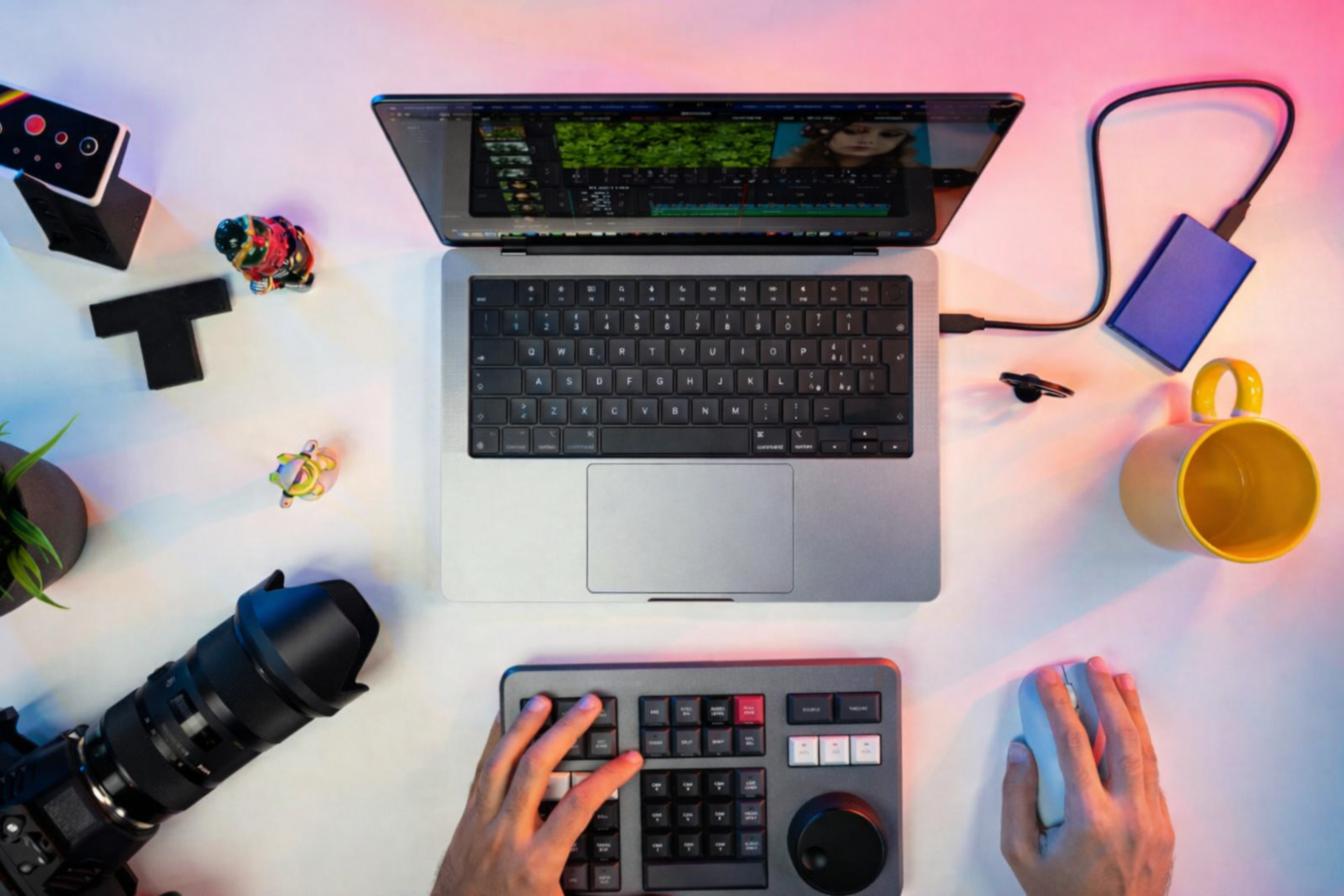 A video editor's desk with camera gear and editing tools